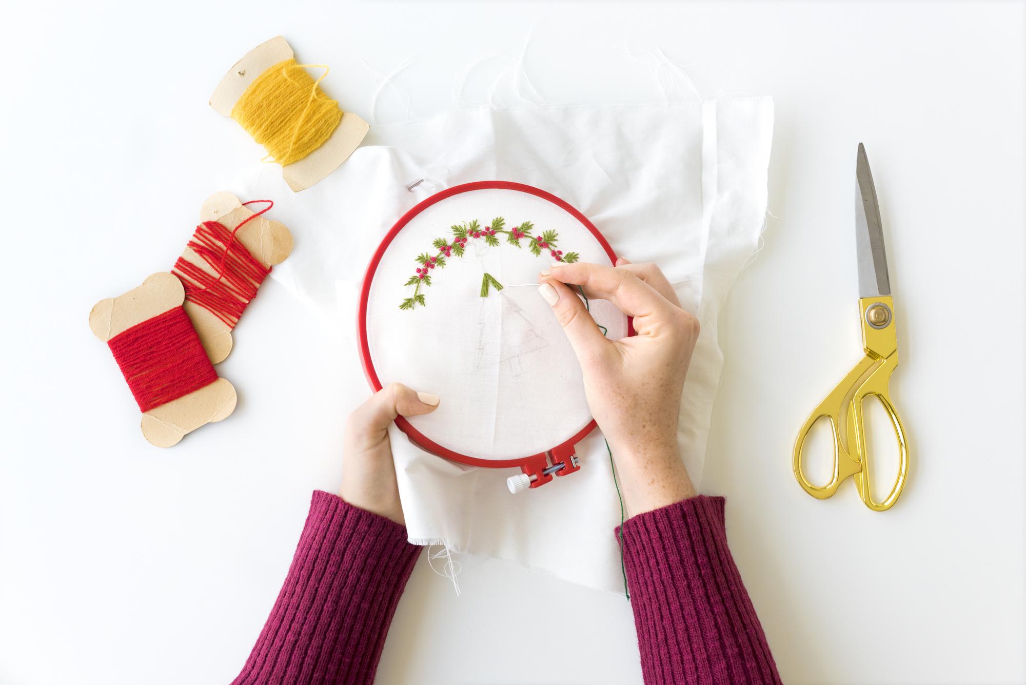 Instructor demonstrating embroidery technique
